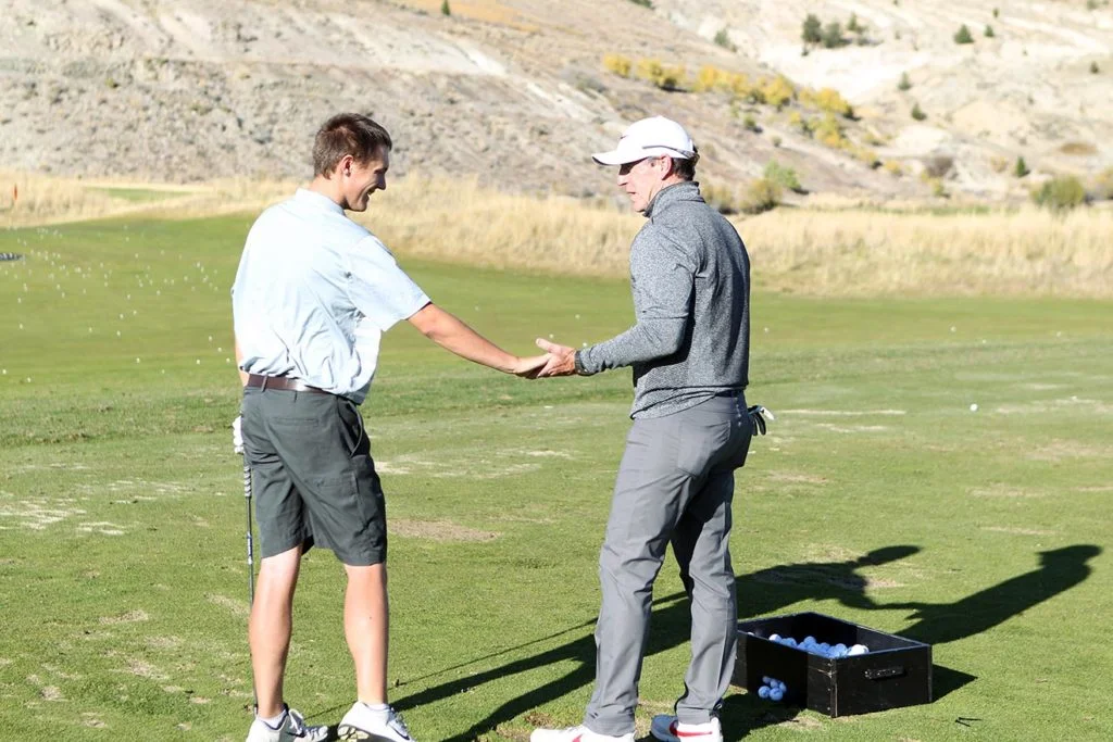 Tim Mahoney connecting with a student on the practice range
